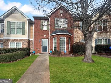 Brick front townhouse with a well-maintained lawn and walkway at 5828 Union Walk Dr, Union City, GA 30291