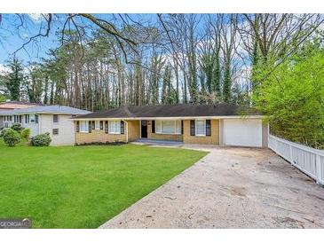 Ranch style home with attached garage and well-manicured lawn at 2798 Engle Nw Rd, Atlanta, GA 30318