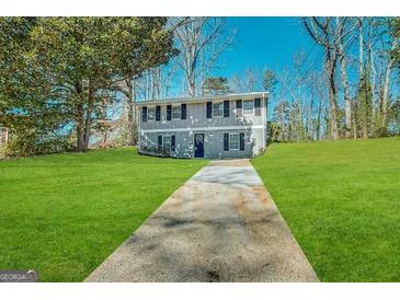 Two-story house with gray siding, a grassy lawn, and a paved driveway at 2852 Port Royal Ln, Decatur, GA 30034