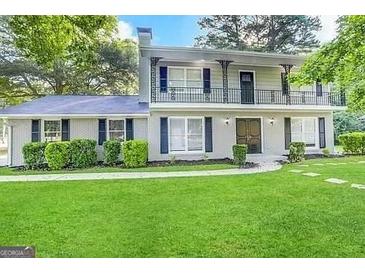 Two-story house with a balcony, freshly painted, and a well-maintained lawn at 2252 Wellington Hills Way, Snellville, GA 30039