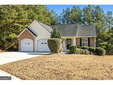 Brick ranch home with two-car garage and landscaped yard at 5690 Cedar Pass, Fairburn, GA 30213