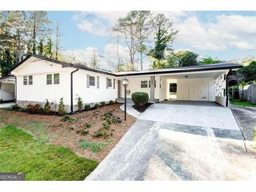 Ranch-style home with carport and landscaped yard at 1883 Fort Valley Dr, Atlanta, GA 30311