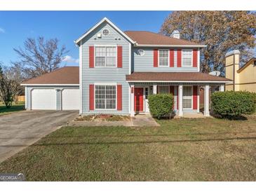 Two-story house with attached garage and red accents at 453 Camp Hill Ln, Jonesboro, GA 30238