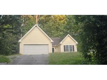 Ranch style home with attached garage, set back from the road with a grassy yard at 221 Lakeview Dr, Stockbridge, GA 30281