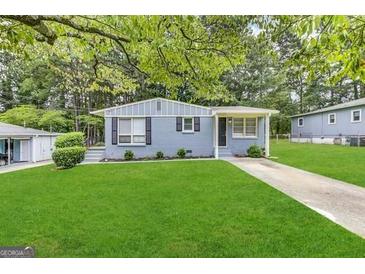 Ranch style home with gray exterior, landscaped lawn, and driveway at 795 Nw Amber Nw Pl, Atlanta, GA 30331