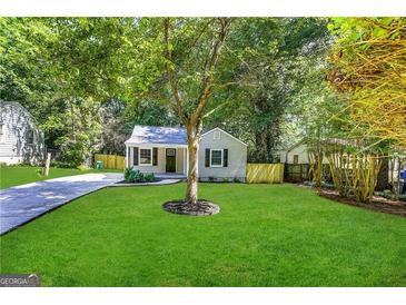 Newly renovated house with a well-manicured lawn and driveway at 3444 Orchard Cir, Decatur, GA 30032