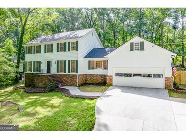 Two-story house with green shutters, brick accents, and a two-car garage at 442 Summit Ridge Dr, Lawrenceville, GA 30046