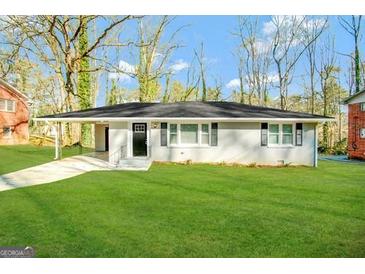 Single-story home with a lush green lawn and covered entrance at 1581 Mcclelland Ave, Atlanta, GA 30344