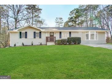 Front exterior of a single-story home with a manicured lawn and updated facade at 464 Stonewood Dr, Stone Mountain, GA 30087