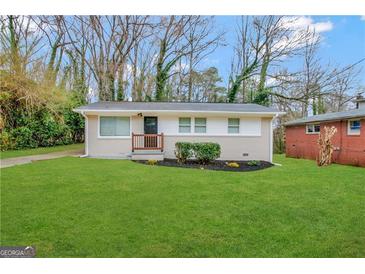 Renovated single-story home with a small front porch, lush green lawn, and mature trees at 3429 Adkins Nw Rd, Atlanta, GA 30331