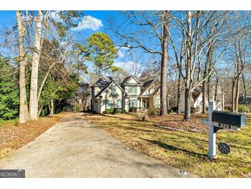 Two-story house with driveway and mature trees at 232 Terrane Rdg, Peachtree City, GA 30269