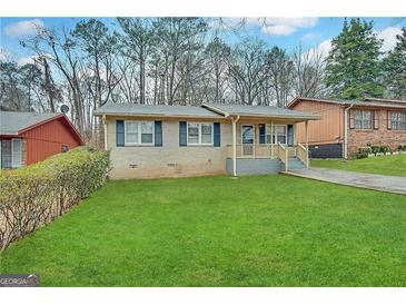 Charming single-Gathering home with lush green lawn and covered porch at 261 Howell Sw Ter, Atlanta, GA 30331