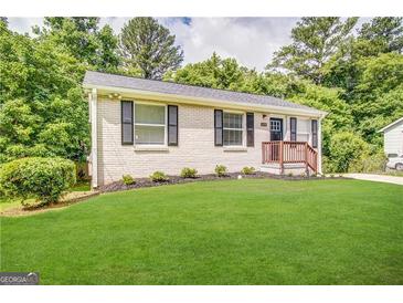 Charming single-story home with a lush green lawn and mature trees at 2843 Marco Nw Dr, Atlanta, GA 30318