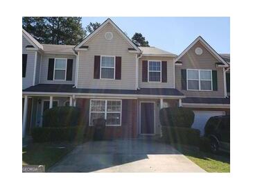 Two-story townhome with attached garage and driveway at 5330 Creekview Ln, Morrow, GA 30260