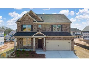 New construction home with a two-car garage and a covered front porch at 655 Edgar St, Hampton, GA 30228