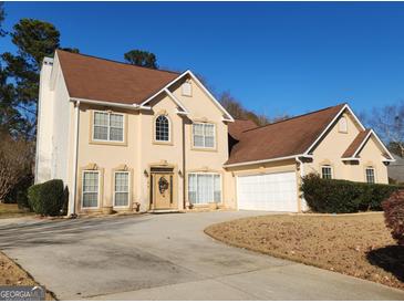 Two story house with attached garage and landscaping at 98 Gleneagles Dr, Fayetteville, GA 30215