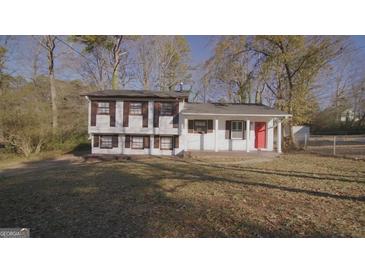 Ranch style home with brick facade and red door, nicely landscaped yard at 2500 Celina Ct, Morrow, GA 30260