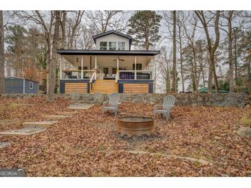 Lakefront home with expansive porch and firepit at 480 Mitchell Rd, Covington, GA 30014