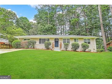 Ranch style home with a spacious lawn and mature trees at 3029 Mckenzie Rd, East Point, GA 30344