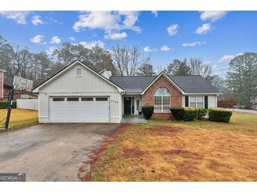 Ranch style home with attached garage and manicured lawn at 3176 Pope Rd, Douglasville, GA 30135