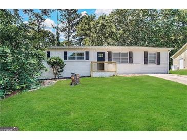 Updated Ranch home features a fresh coat of paint and a well-manicured lawn at 10178 Allen Sw Dr, Covington, GA 30014