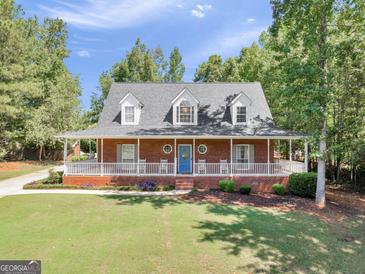 Brick house with wrap-around porch, and nice landscaping at 1302 Eddie Craig Ct, Mcdonough, GA 30252