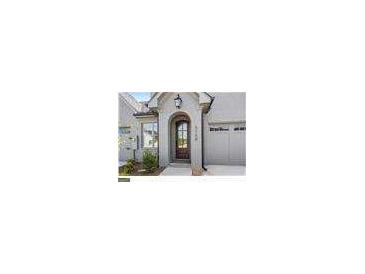 Inviting exterior with charming front door and attached garage at 5158 Noble Village Way # 35, Lilburn, GA 30047