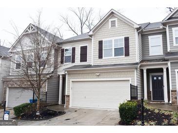 Two-story townhome with attached garage and neutral siding at 1058 Mays Hill, Atlanta, GA 30336