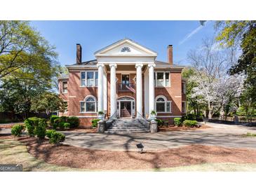 Brick two story home with columns and landscaped yard at 2204 Monticello St, Covington, GA 30014