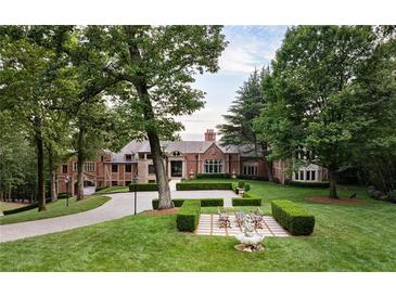 Large brick house with landscaped lawn and circular driveway at 4665 Riverview Rd, Atlanta, GA 30327
