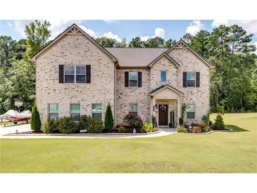 Two story house with brick facade and large grassy yard at 1025 Fable Ln, Hampton, GA 30228