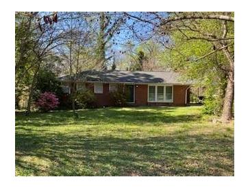 Brick ranch home with large front yard and mature trees at 456 Big John Se Trl, Marietta, GA 30067