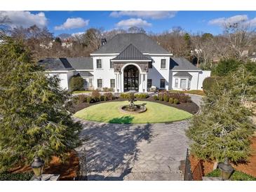 Elegant home with circular driveway and fountain at 4571 Columns Se Dr, Marietta, GA 30067
