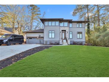 Modern home exterior with attached garage and basketball court at 2334 Paces Ferry Se Rd, Smyrna, GA 30080