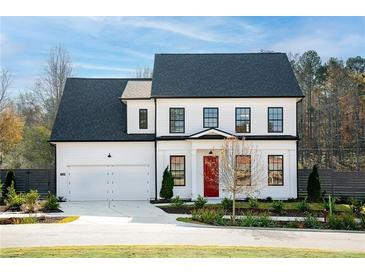 Two-story home with white siding, black trim, and a red front door at 428 10Th St, Auburn, GA 30011