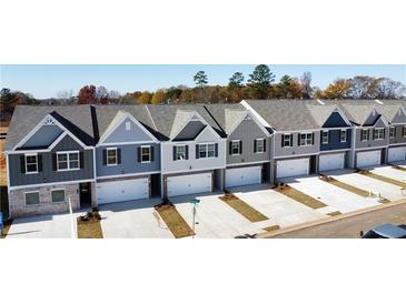 Row of new townhouses with attached garages at 11682 Chatham Dr, Hampton, GA 30228