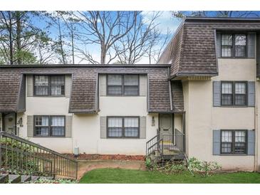 Attractive exterior of a townhouse with a nicely landscaped lawn at 169 Barone Nw Pl, Atlanta, GA 30327