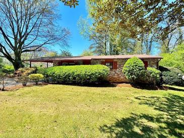 Brick ranch house with landscaped yard at 650 Lyric Nw Way, Atlanta, GA 30318