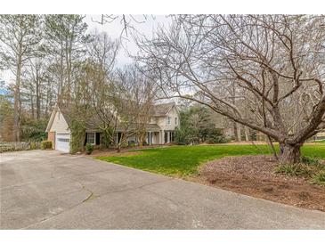 Ranch-style house with attached garage and a large yard at 380 Stone Mill Trl, Atlanta, GA 30328