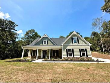 Two-story house with gray siding and a front porch at 22 Stratford Way, Kingston, GA 30145