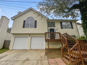 Two-story house with attached garage and deck at 5789 Wellborn Creek Dr, Lithonia, GA 30058