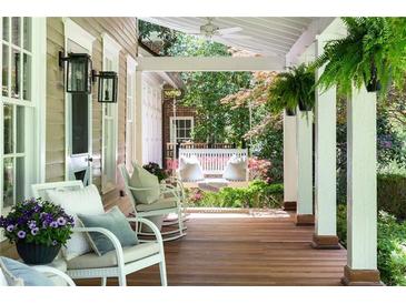 Inviting front porch with rocking chairs and a porch swing, perfect for relaxing outdoors at 11 Demorest Ne Ave, Atlanta, GA 30305