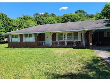 Brick ranch house with a carport and lawn at 3321 S Norcross Tucker Rd, Tucker, GA 30084