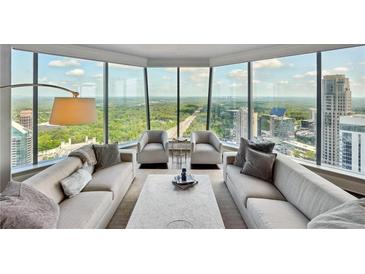 Luxury living room with floor-to-ceiling windows and city views at 3344 Peachtree Ne Rd # 3902, Atlanta, GA 30326
