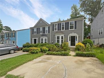 Two-story townhome with gray siding and landscaping at 3316 Merlot Pass, Lawrenceville, GA 30044