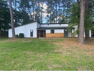 Modern exterior with white siding and wood accents at 51 Holt Ne Rd, Marietta, GA 30068