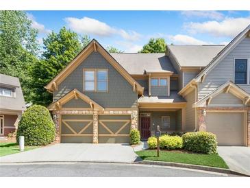 Two-story townhome with gray siding, two-car garage, and landscaping at 1400 Village Creek Se Cir # 12A, Atlanta, GA 30316