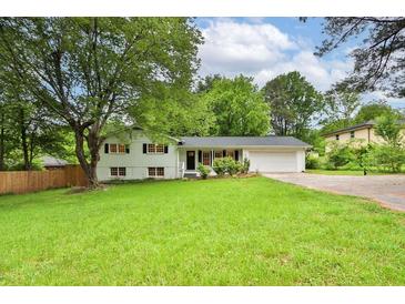 Charming ranch home with white brick exterior, black shutters, and spacious yard at 1531 Piedmont Ne Rd, Marietta, GA 30066