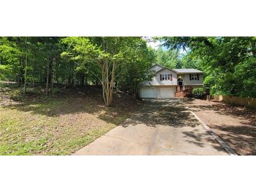 Two-story house with attached two-car garage and deck at 2470 Cambridge Hills Rd, Cumming, GA 30041