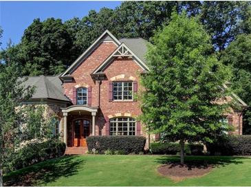 Brick house with a large front yard and landscaping at 319 Summer Garden Dr, Marietta, GA 30064
